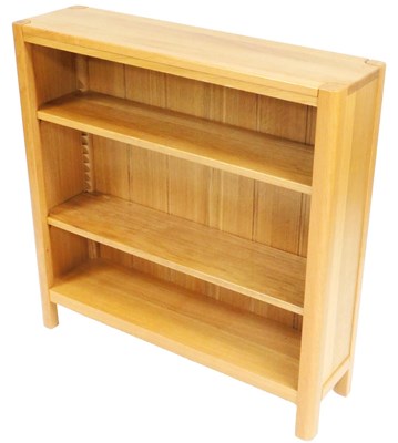 Lot 781 - A light oak bookcase, with a signature leaf...