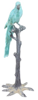 Lot 789 - A patinated bronze figure of a parrot, perched...