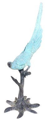 Lot 790 - A patinated bronze figure of a parrot, perched...