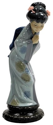 Lot 670 - A Lladro porcelain figure of a geisha...