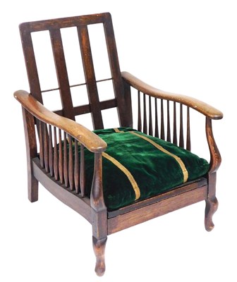 Lot 808 - An early 20thC oak lounge chair, with a loose...