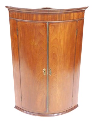 Lot 836 - A George III mahogany bow front corner...