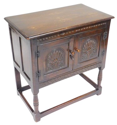 Lot 848 - A 17thC style oak cupboard, with two carved...
