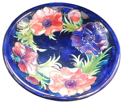 Lot 128 - A Moorcroft pottery dish decorated in the...