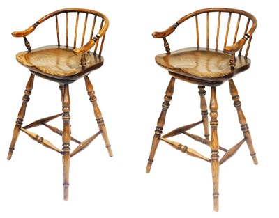 Lot 865 - A pair of ash low Windsor back swivel bar...