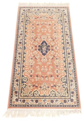 Lot 872 - A Caucasian pink ground rug, with a central...