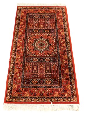Lot 873 - A Kashqai red ground rug, the central field...