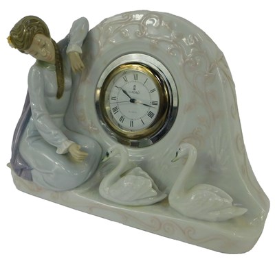 Lot 103 - A Lladro porcelain clock, the circular white...