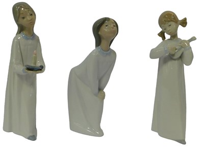 Lot 151 - Three Lladro porcelain figures, each wearing a...