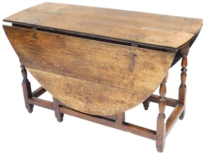 Lot 886 - A Georgian oak drop leaf dining table, raised...