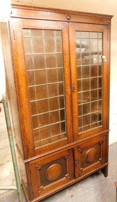 Lot 1132 - An oak display cabinet, with two leaded glazed...