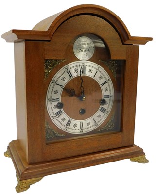 Lot 110 - A 20thC teak cased mantel clock, the dial...