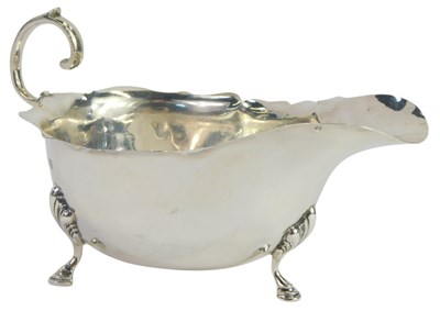 Lot 361 - A George V silver sauce boat, with a fluted...