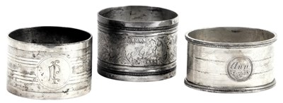 Lot 456 - Three silver napkin rings, to include a...