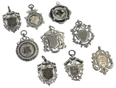 Lot 500 - A group of silver shield and other fobs, some...