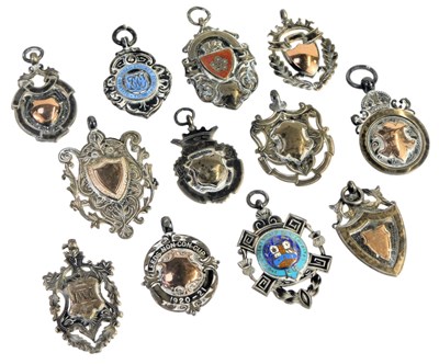 Lot 501 - A group of silver shield and other fobs, some...