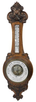 Lot 515 - A Victorian carved oak cased banjo aneroid...
