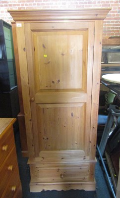 Lot 1001 - A pine wardrobe, single door over drawer,...