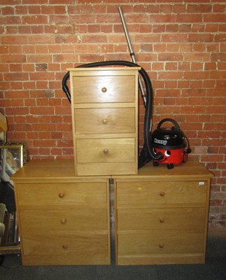 Lot 1005 - Two three drawer chests, in a lightwood finish,...
