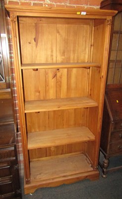 Lot 1007 - A pine bookcase, of four shelves, with carved...