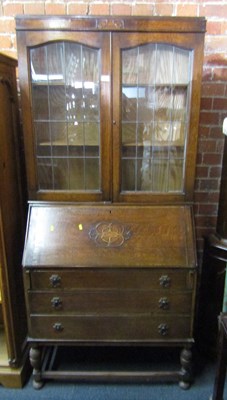 Lot 1025 - An oak bureau bookcase, with two leaded glazed...