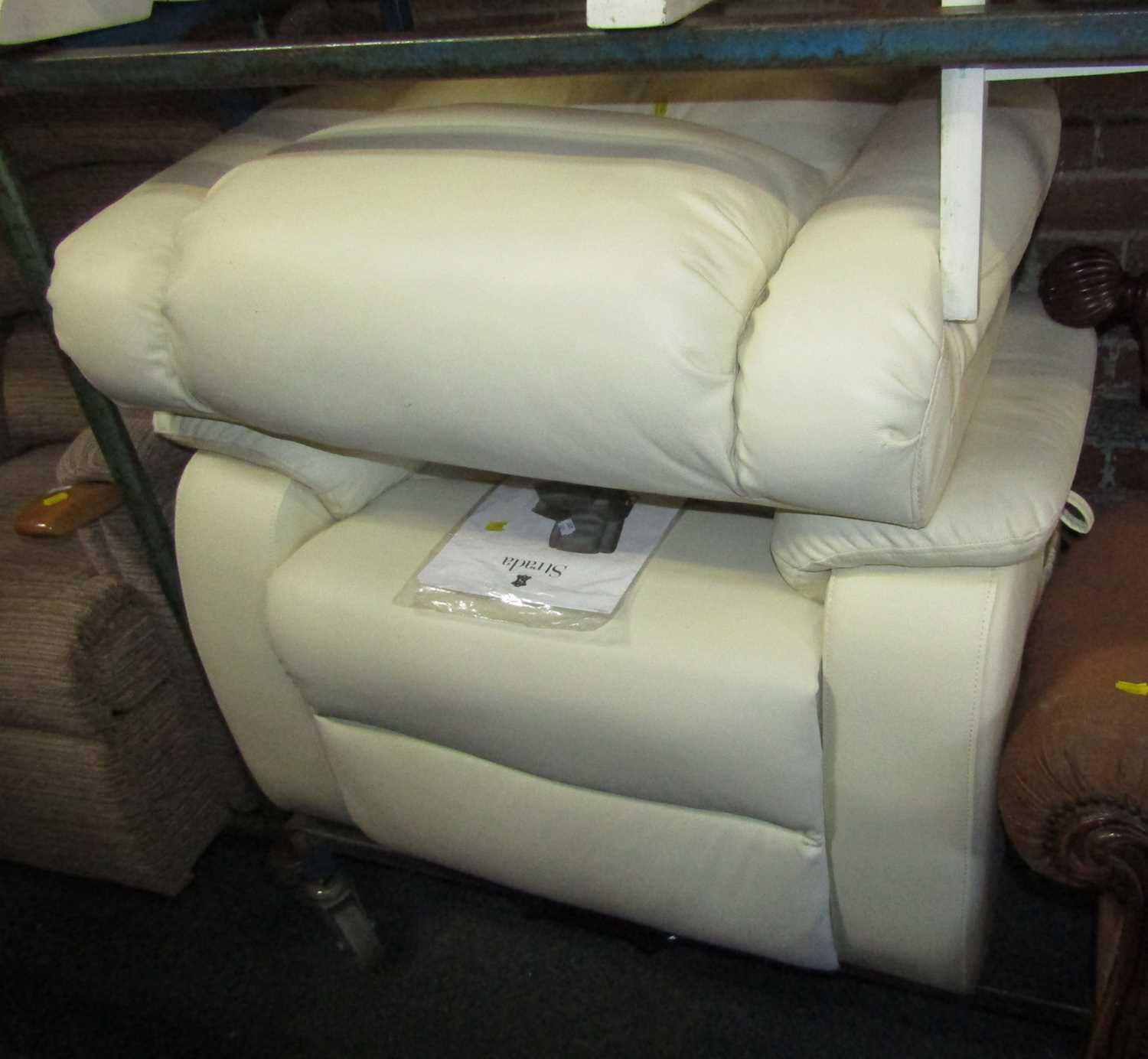 Lot 1029 - A white or cream leather upholstered electric...