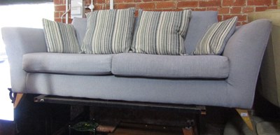 Lot 1011 - A blue upholstered two seater sofa.