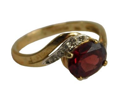 Lot 299 - A QVC red stone and diamond ring, possibly a...