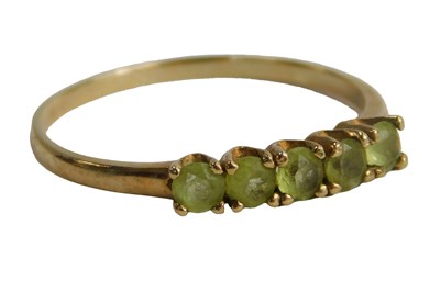 Lot 579 - A 9ct gold five stone peridot ring, claw set,...