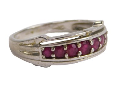 Lot 581 - A QVC 9ct white gold and ruby seven stone ring,...
