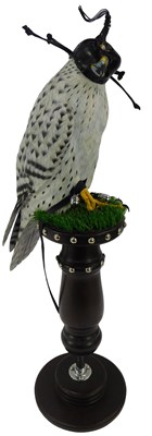 Lot 526 - A resin model of a falcon, wearing a black...