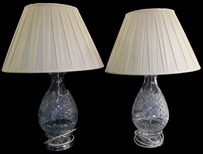 Lot 543 - A pair of cut glass table lamps, of baluster...