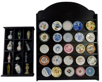 Lot 562 - Two shelving displays, enclosing miniature...