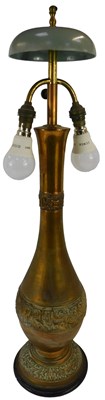 Lot 570 - An Eastern embossed copper table lamp, of...