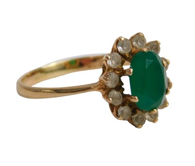 Lot 616 - A green and white stone cluster ring, the oval...