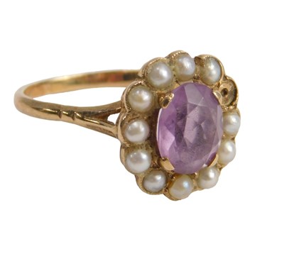Lot 607 - An amethyst and seed pearl cluster ring, the...