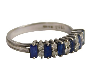 Lot 614 - An 18ct white gold diamond and sapphire ring,...