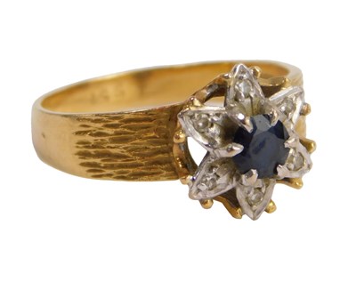 Lot 615 - An 18ct gold sapphire and diamond flower head...