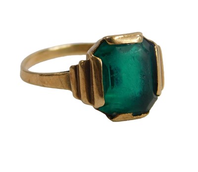 Lot 609 - A 9ct gold and green stone ring, tension set,...