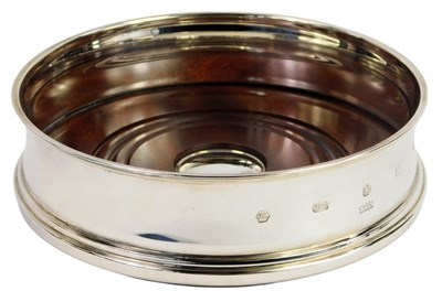 Lot 619 - An Elizabeth II silver wine coaster, with a...