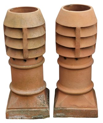 Lot 678 - A pair of terracotta chimney pots, 80cm high.