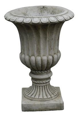 Lot 679 - A painted composition stone garden urn, on a...