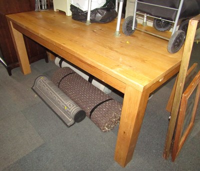 Lot 1078 - A large lightwood dining table, on four square...