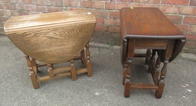 Lot 1082 - Two small drop flap tables, raised on turned...