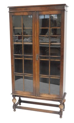 Lot 713 - A 20thC oak display cabinet, the top with a...
