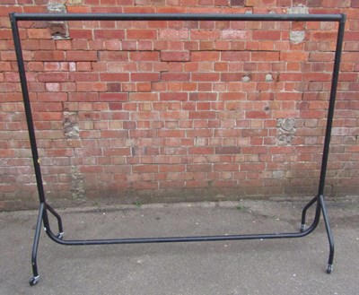 Lot 1122 - A metal clothes rail, raised on castors.