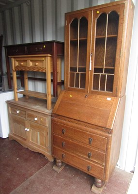 Lot 1114 - An oak bookcase bureau, two glazed doors over...