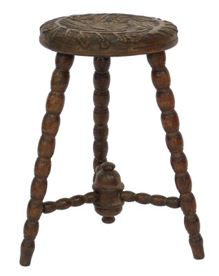 Lot 773 - A 19thC oak country stool, the circular top...