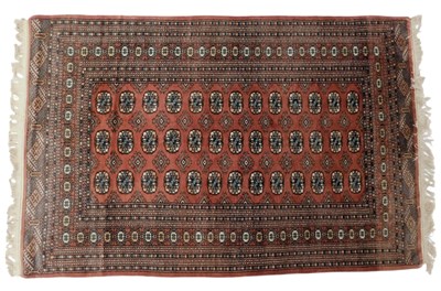 Lot 818 - A Pakistani pink ground rug, decorated with...