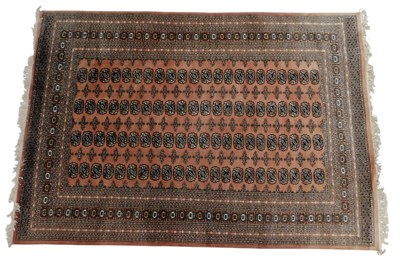 Lot 820 - A Persian Bokhara pink ground rug, decorated...